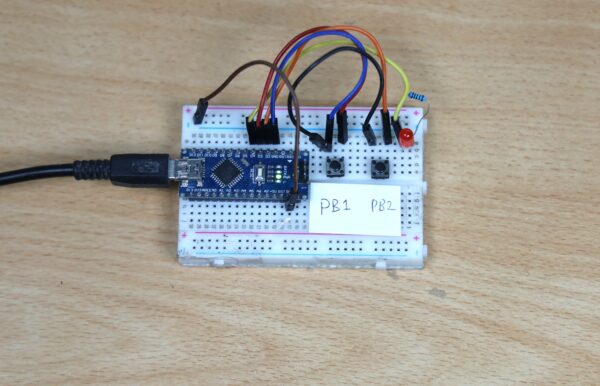 Rangkaian lampu on-off  dengan breadboard. Mikroprosesor Arduino Nano ATmega328,  2 buah push button, 1 buah LED dengan resistor 1k